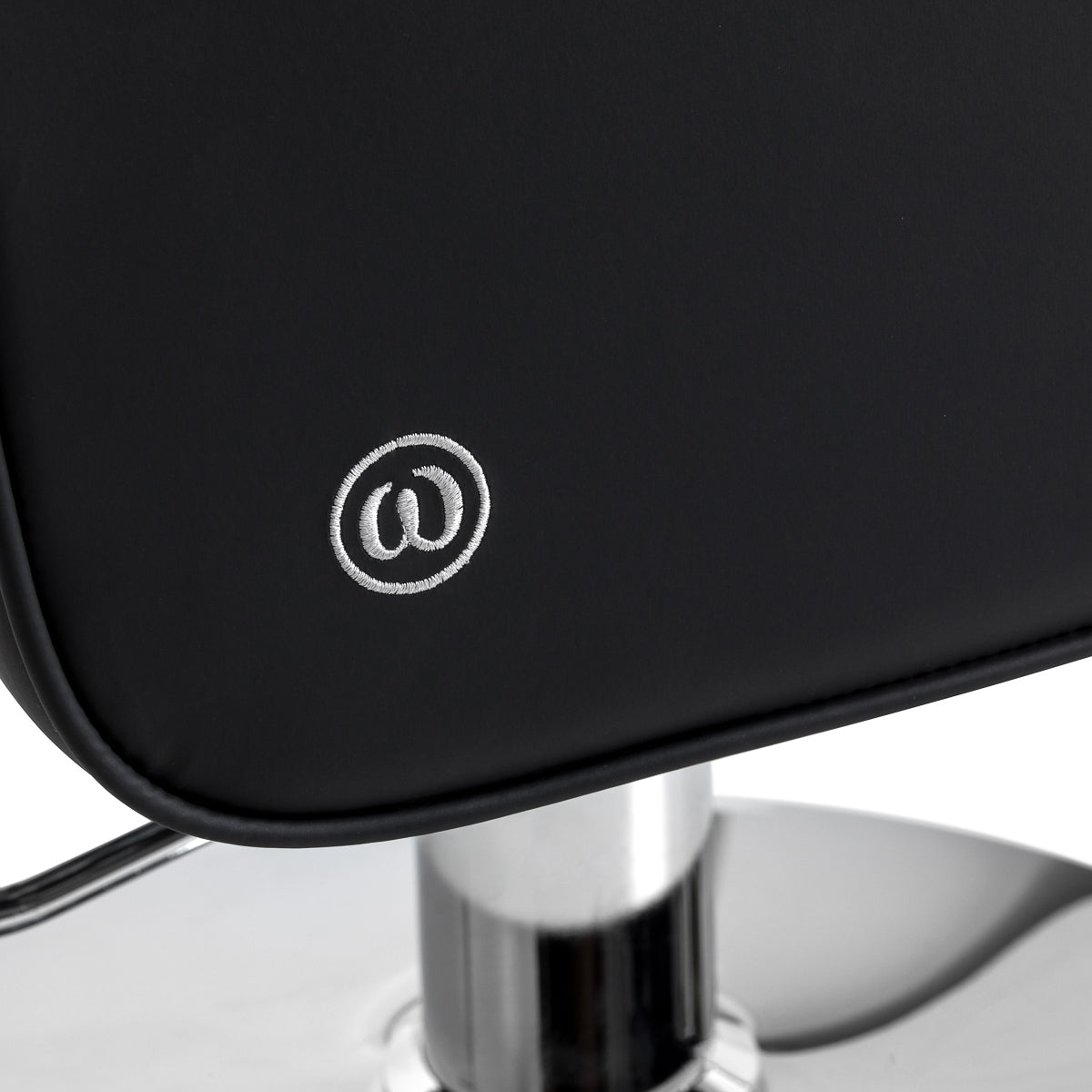 Black Omega Andromeda hairdressing chair with adjustable height and cushioned seat for salon styling.