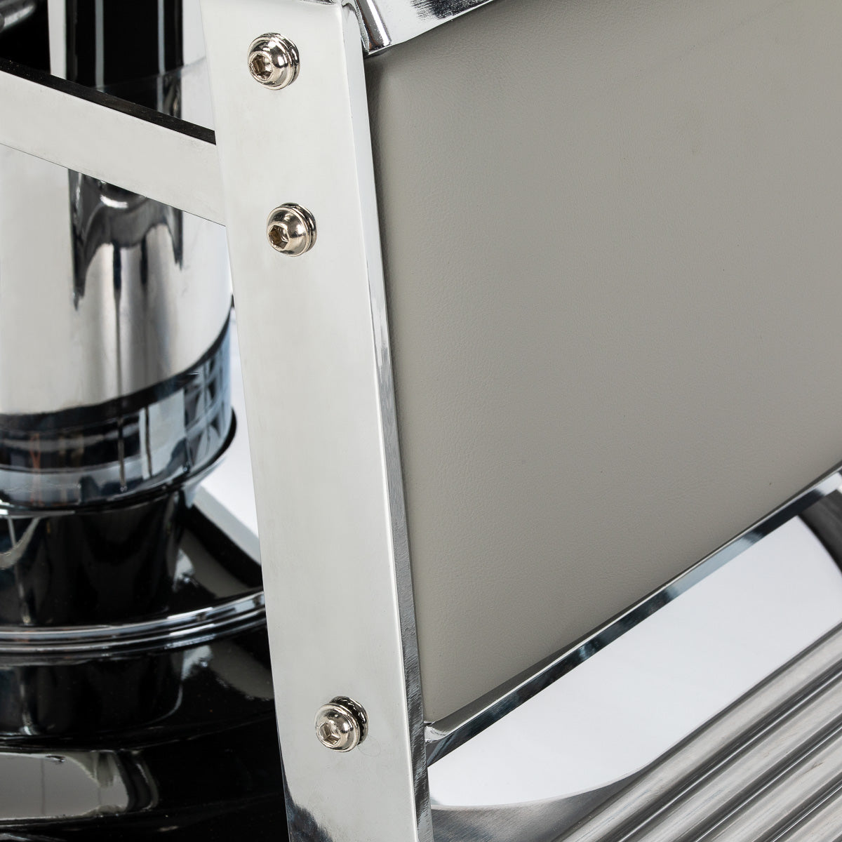 Gabbiano Visionerio grey barber chair with chrome frame, padded seat and backrest, in a professional barbershop setting.