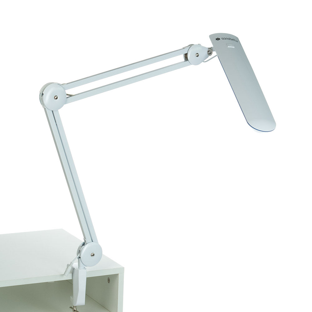 Sonobella Moon LED clip-on workshop lamp by Beauty System, showing a sleek, adjustable lamp with bright LED light and clip attachment.
