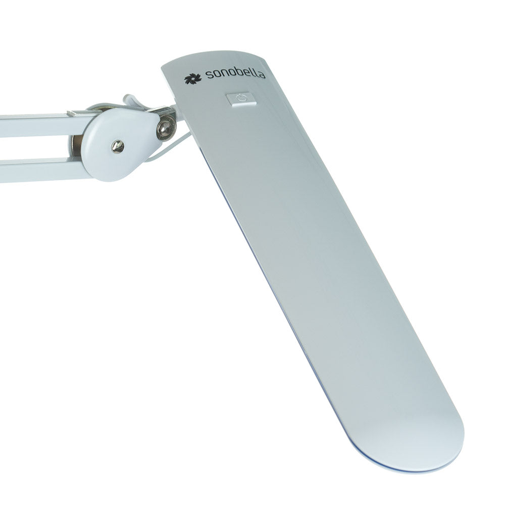 Sonobella Moon LED workshop lamp by Beauty System with clip, featuring adjustable arm and bright illumination.
