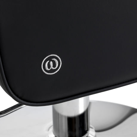 Black Omega Andromeda hairdressing chair with adjustable height and cushioned seat for salon styling.