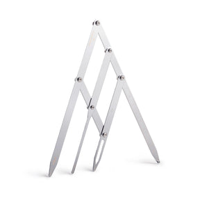 The Perma Golden Ratio Divider Brow Compass shown with metal arms and measurement markings for precise eyebrow shaping.